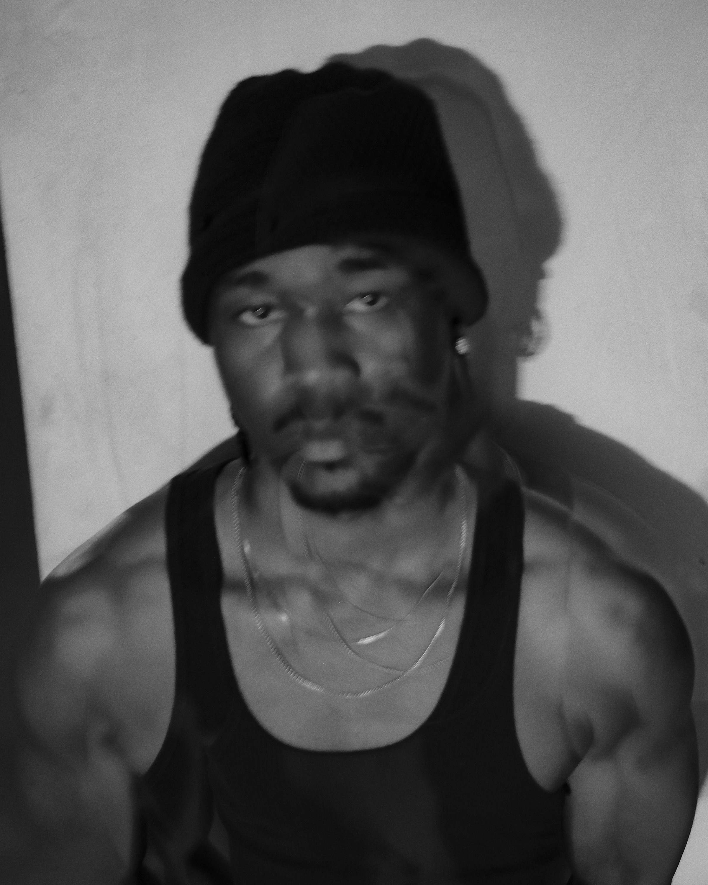Close-up of FUNSYDE in a beanie and chains, slight motion blur