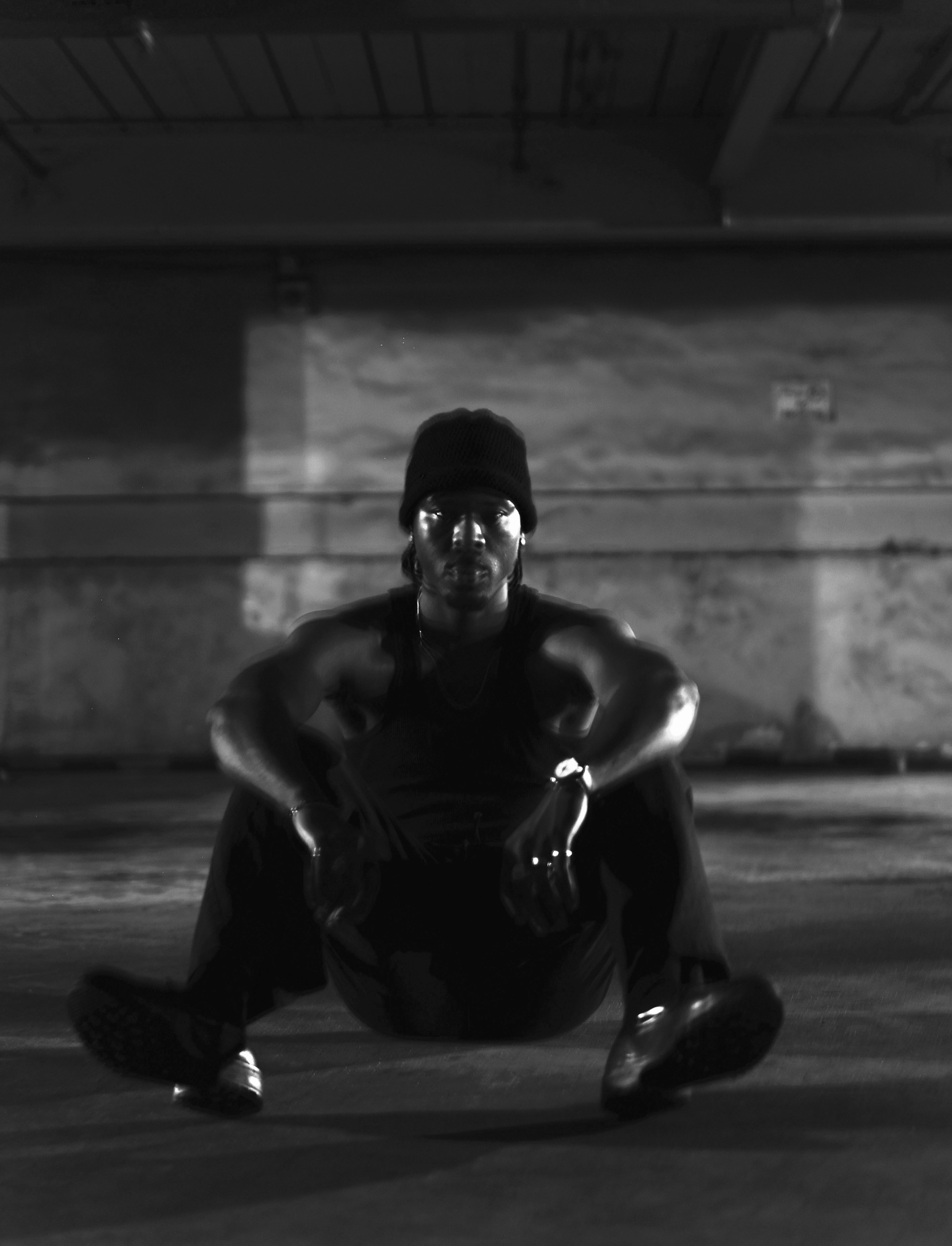 FUNSYDE seated on a garage floor, staring into the camera